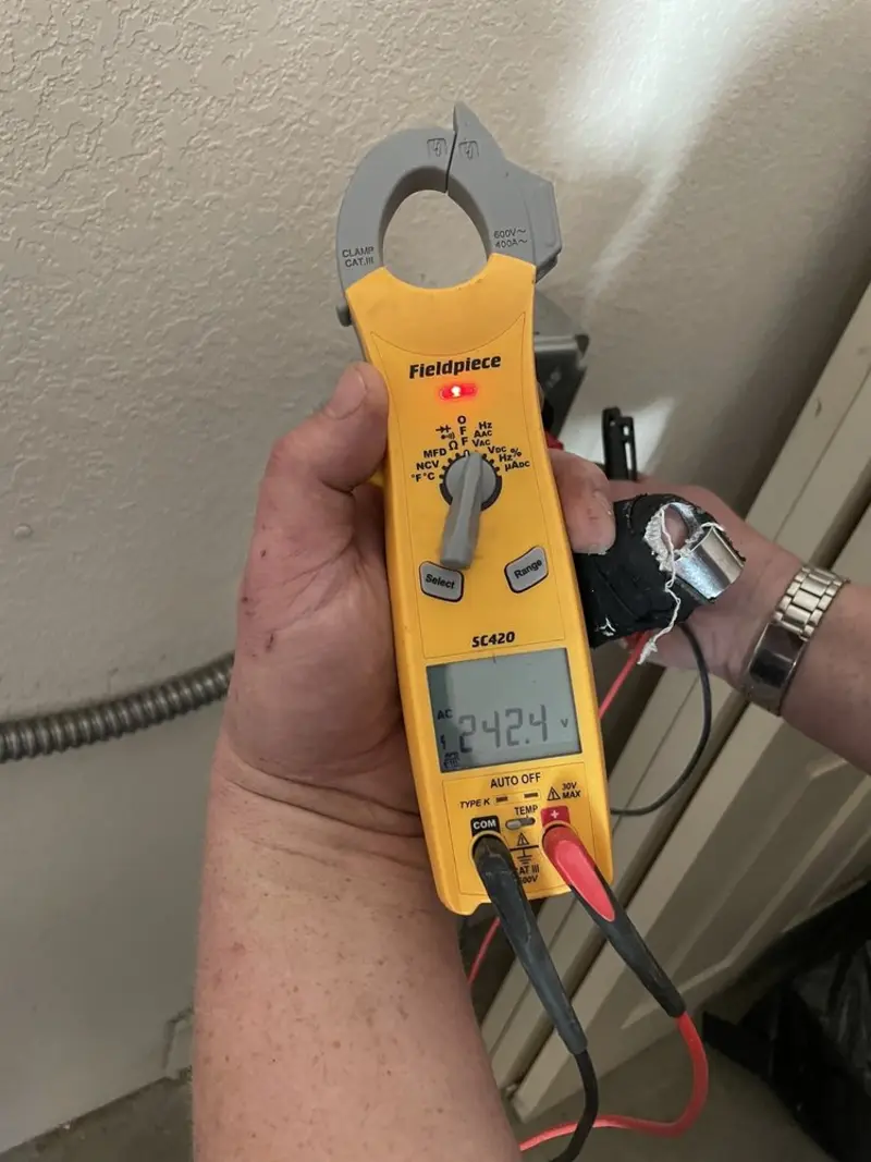 Voltage testing with clamp meter during Recessed Lighting Installation in Rives